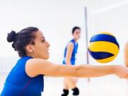 A lady practicing volleyball drills.