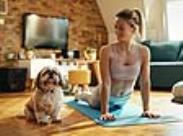 woman doing yoga with her dog-front