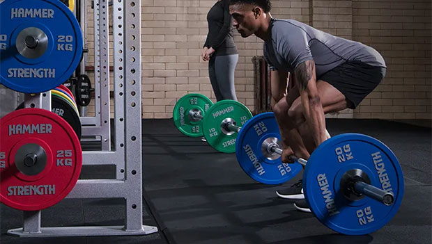 people lifting barbells with bumper plates