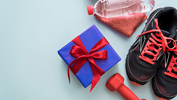 running-shoes-and-workout-equipment-with-a-wrapped-gift