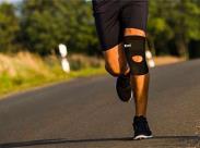 man-running-on-a-road-while-wearing-a-knee-brace