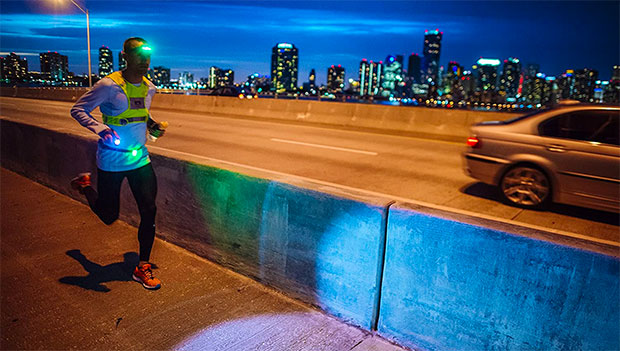 man-wearing-reflective-gear-while-running-at-night
