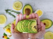 person-holding-avocado-and-egg-toast