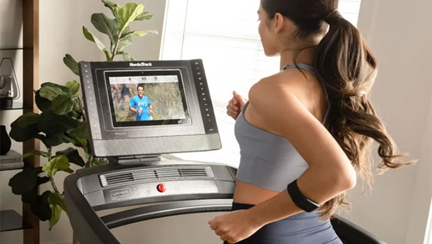 woman using the Nordictrack commercial 1750 treadmill