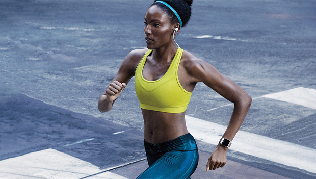 woman running with fitbit
