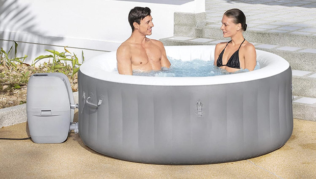 Couple using an inflatable hot tub
