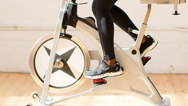 woman riding spin bike with spin shoes
