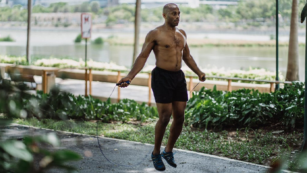 man jumping with weighted jump rope