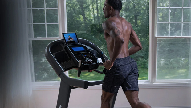 Man using 7.4 AT Studio Treadmill