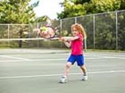 kid playing tennis