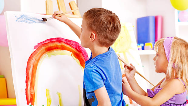 two kids painting a rainbow
