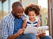 father and daughter reading a book-front