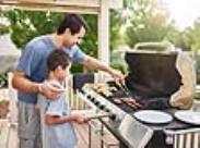 father and son at the grill-front