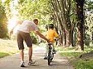dad with son riding a bike-front