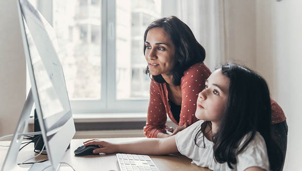 child and parent at a computer