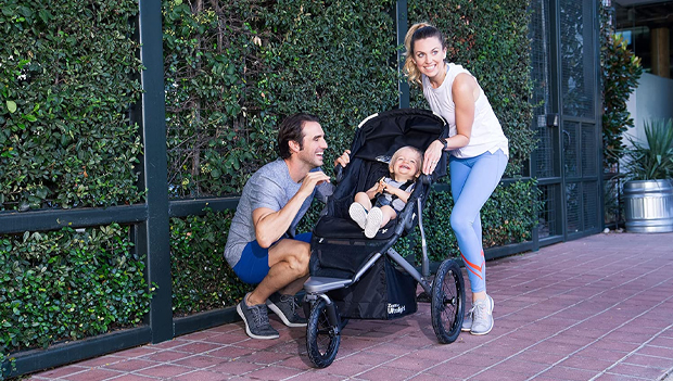 parents with child in jogging stroller