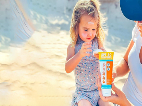 Parent applying sunscreen to child