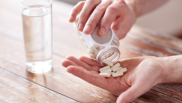 person holding pills