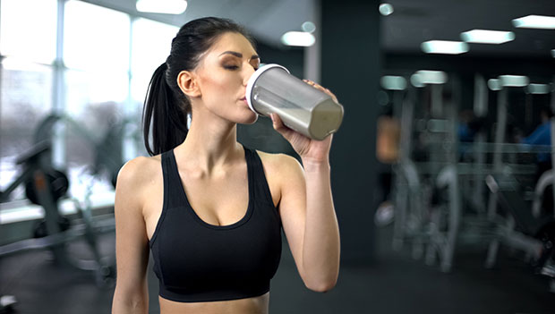 woman drinking a protein shake