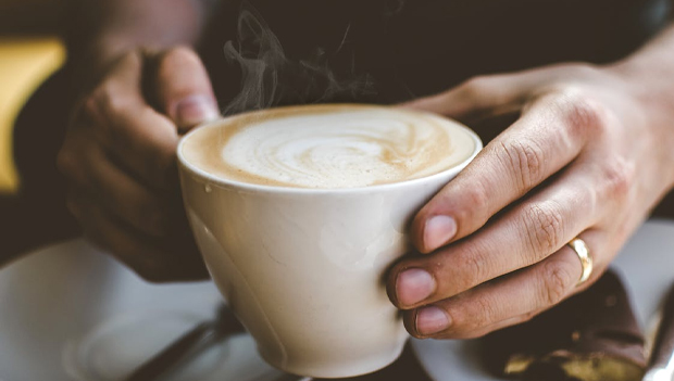 Close-Up Photo of Person Holding Cup of Coffee