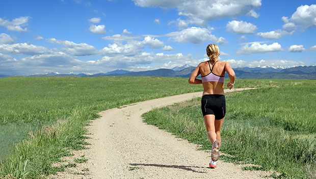 Woman Running on a Open Trail