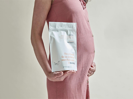 pregnant woman holding vitamins