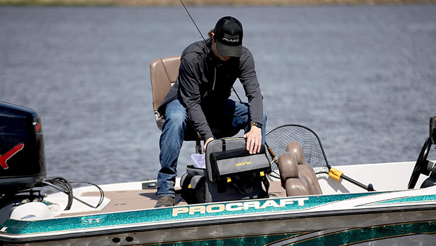 man-opening-a-tackle-box-on-a-boat