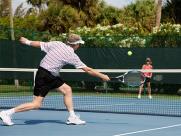 man reaching for a tennis shot